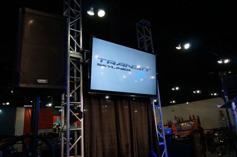 1993 Ford Taurus - A screen displays "TRANSIT SKYLINER" at an event, with audio equipment and stage lighting visible.