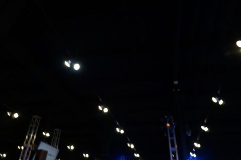 1993 Ford Taurus - A dark scene with numerous spotlights and stage rigging, suggesting an indoor event or performance space.