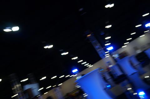 1993 Ford Taurus - The interior of a convention center is captured with motion blur, showing rows of lights and blue accents.