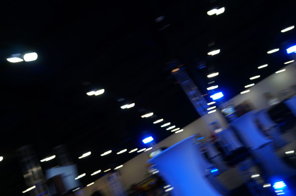 Interior of a convention center with blurred blue and white lights