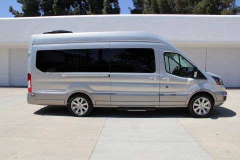1993 Ford Taurus - A silver van with a two-tone paint scheme and running boards is parked on a concrete surface.