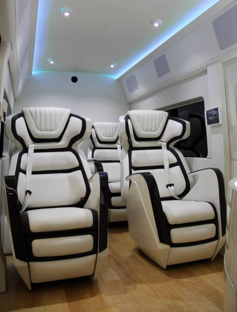 1993 Ford Taurus - Interior view of a van's custom seating arrangement with ambient lighting.