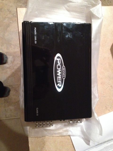 2005 Jeep Wrangler - A black Jensen car amplifier with "POWER 1500.5D" and "CLASS D" visible is shown.
