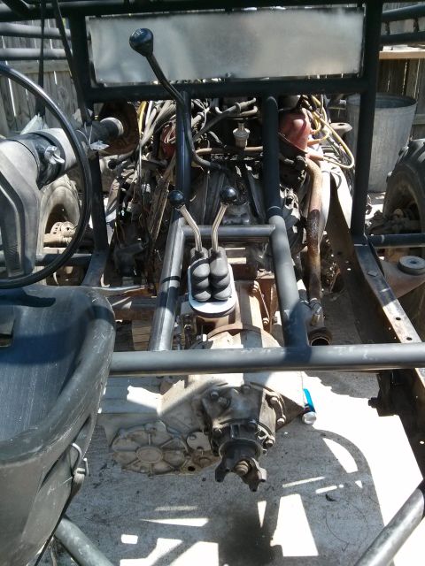 1986 Ford Bronco - This image shows the interior of a vehicle, focusing on the engine, transmission, and a roll cage, with no visible year identification.