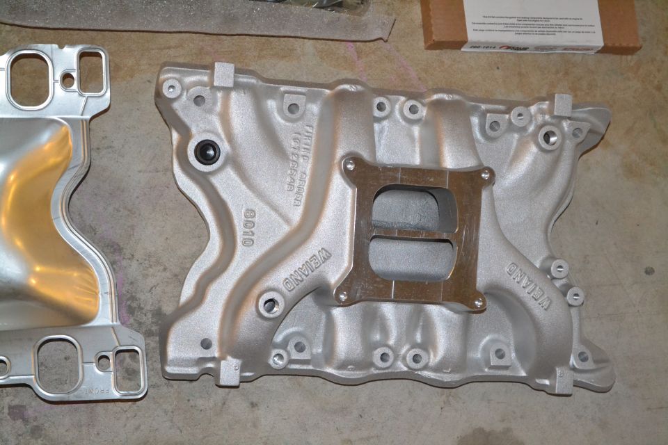 Two aluminum intake manifolds, one labeled WEIAND
