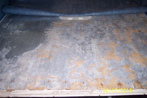 1990 Ford Bronco - Corroded metal floor panel, possibly from a vehicle's cargo area.