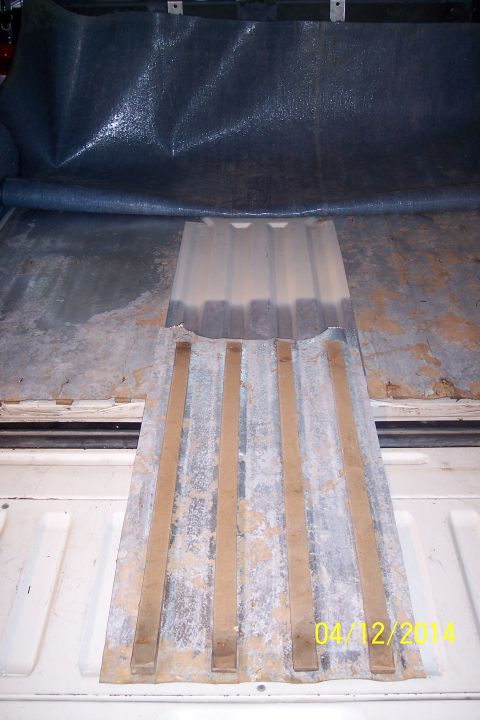 1990 Ford Bronco - Close-up of a fuel floor access panel with visible wooden slats and a date stamp of 04/12/2014.