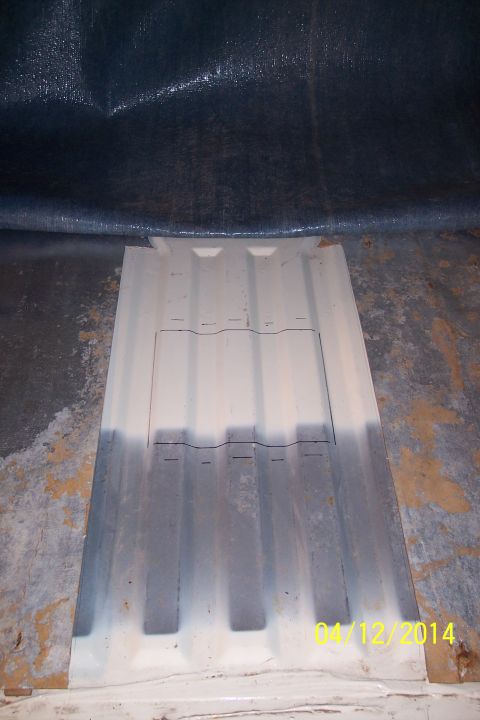1990 Ford Bronco - A close-up view of a vehicle's floor panel, showing its ribbed texture and a central access cutout.