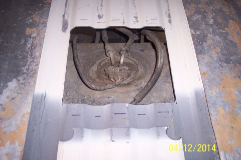 1990 Ford Bronco - Access panel removed to show the fuel tank and associated lines.
