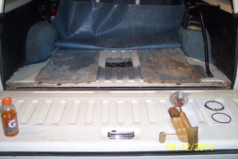 1990 Ford Bronco - Fuel pump assembly and a Gatorade bottle are visible in the cargo area of a truck.