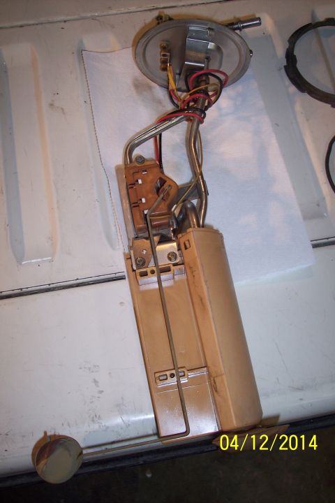 1990 Ford Bronco - A removed fuel pump assembly, showing its internal components and wiring, with a date stamp of 04/12/2014.