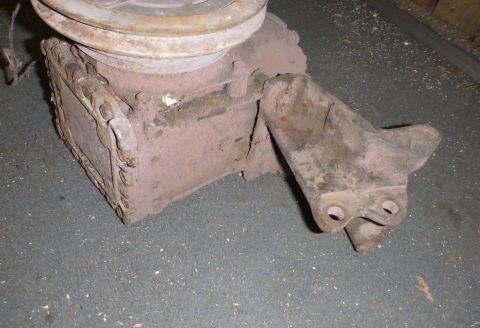 1964 Mercury Monterey - This is a close-up of a rusty automotive part with a pulley, likely a pump.