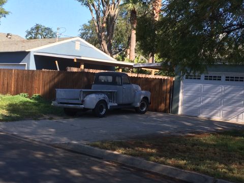 1968 Ford Mustang - An old pickup truck sits in a driveway, awaiting restoration.