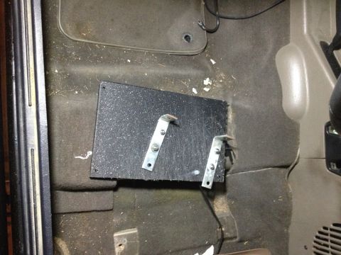 2005 Jeep Wrangler - A custom bracket is mounted to the floor of a vehicle's interior.