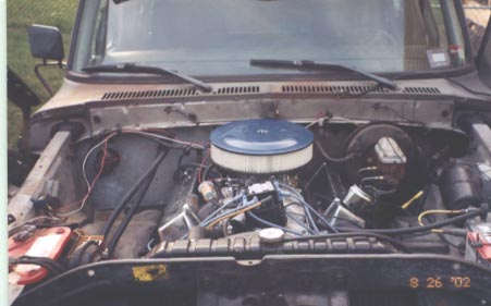 1979 Ford Bronco - The engine bay of a 1979 Ford Bronco shows its V8 engine with a prominent blue air filter.