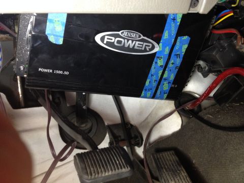 2005 Jeep Wrangler - A Jensen Power 1500.5D amplifier is visible under the dashboard, held in place with blue tape.