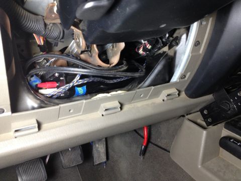2005 Jeep Wrangler - Wiring and RCA cables are visible under the dashboard of a vehicle.