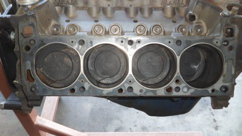 1972 Ford Ranchero - Close-up view of an engine block's cylinder bank, revealing pistons with signs of wear and damage.