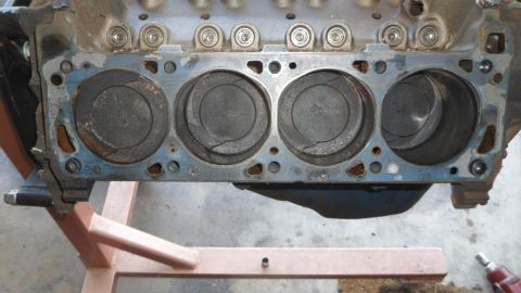 1972 Ford Ranchero - Close-up view of an engine block, showing four pistons within their cylinders. The block is supported by a stand.