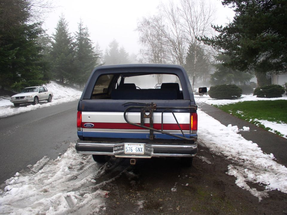 Rear view of 1988 Ford Bronco with red and white stripe, license plate 576 GNX
