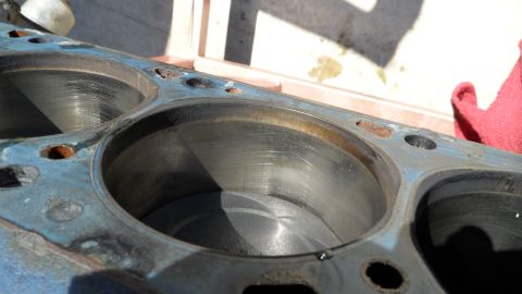 1972 Ford Ranchero - Close-up of an engine block's cylinders, with visible wear and some rust on the metal.