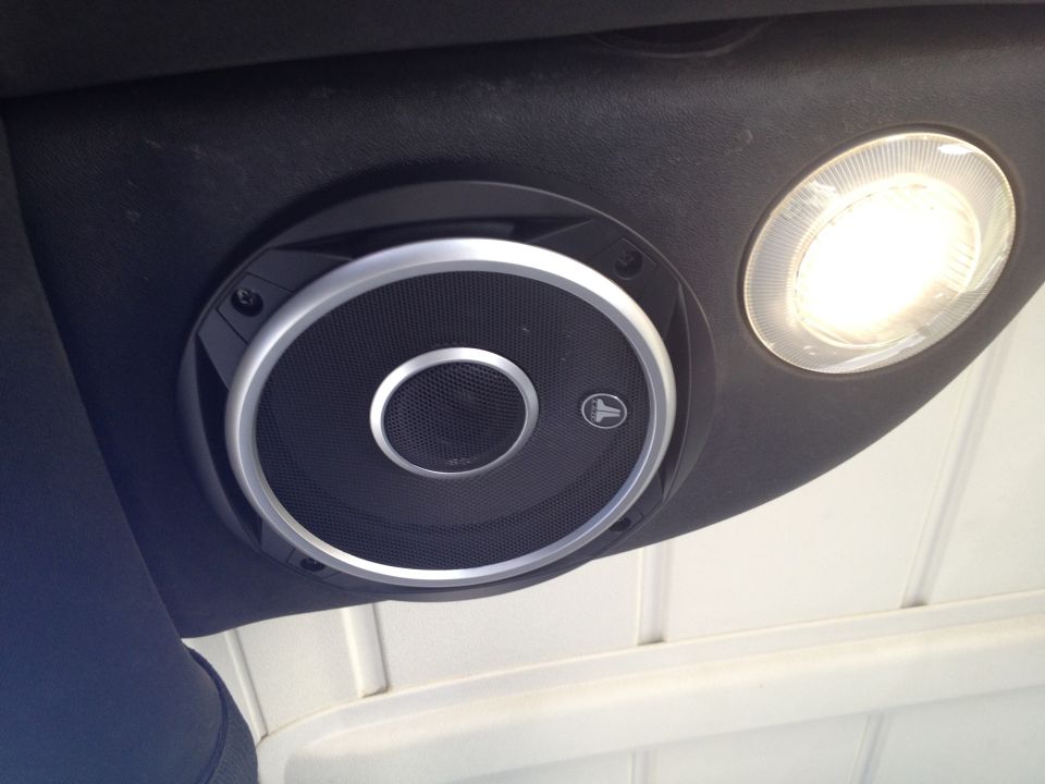 Close-up of a JL Audio speaker and interior light on a vehicle's headliner