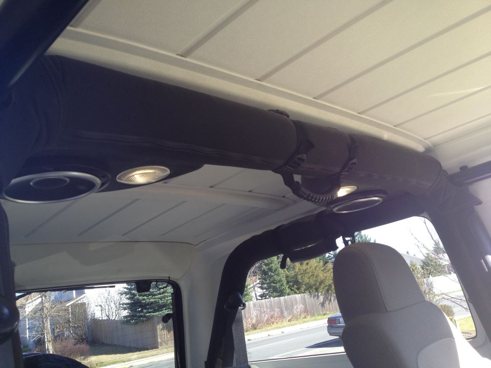 Interior shot of a Jeep showing overhead speakers and dome lights