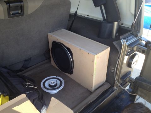 2005 Jeep Wrangler - A subwoofer box and speaker are visible in the cargo area of a Jeep Wrangler.