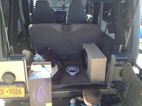 2005 Jeep Wrangler - Subwoofer box and speakers are loaded into the cargo area of a 2005 Jeep Wrangler.