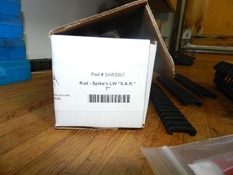 1996 Ford Bronco - A box labeled with part number SAR3207 and rail sections are on a wooden surface.