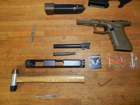 1996 Ford Bronco - Handgun parts laid out for assembly or maintenance on a wooden table.