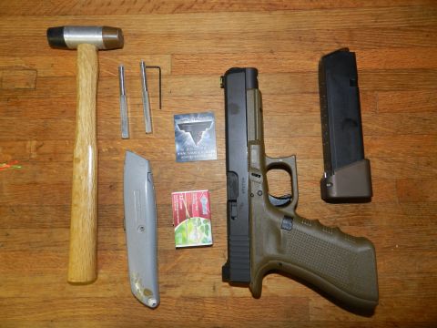 1996 Ford Bronco - Various tools and a handgun are laid out on a wooden surface, with a SuperMotors watermark visible.