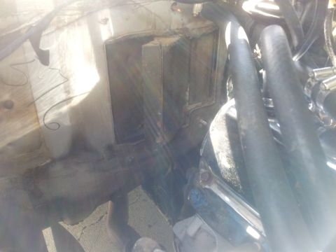 1976 Ford Ranchero - Engine bay detail showing hoses and a black rectangular component.