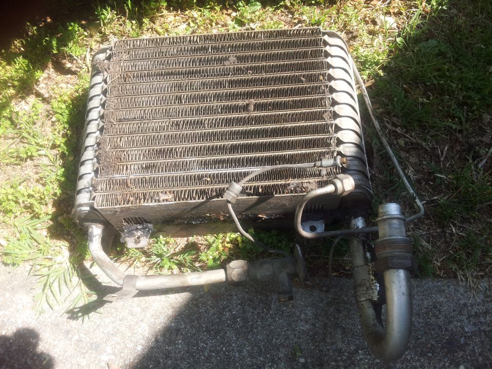car AC condenser unit sitting on the ground