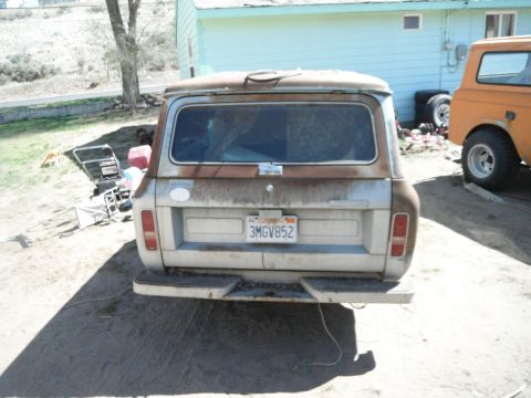 1972 International Scout II - A weathered International Scout II is parked outdoors next to an orange vehicle.