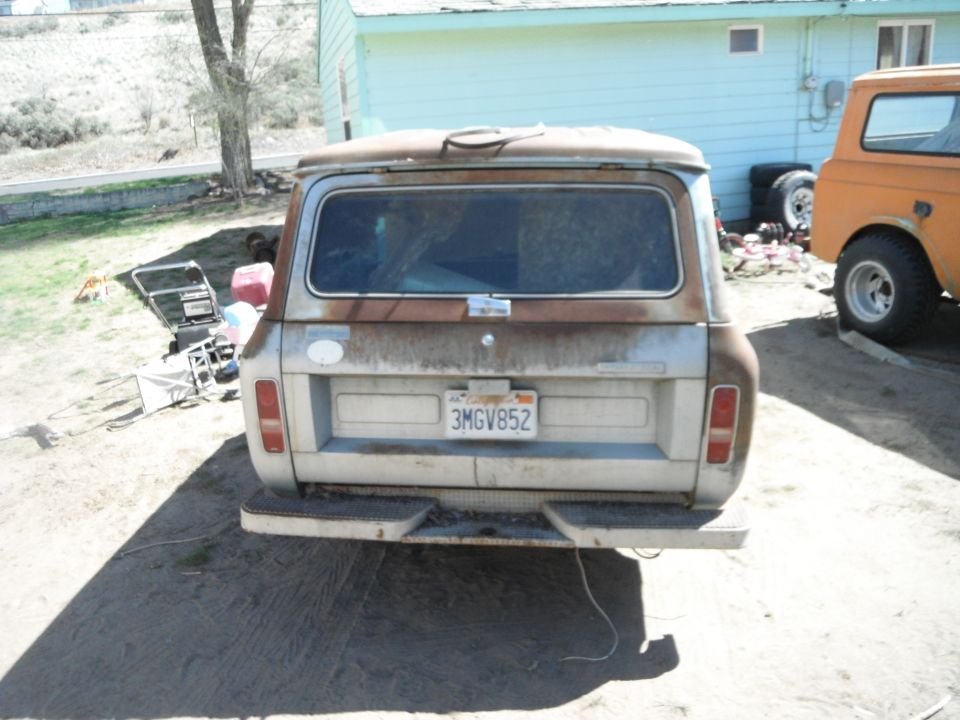Rusty white International Scout II rear view with California license plate 3MGV852