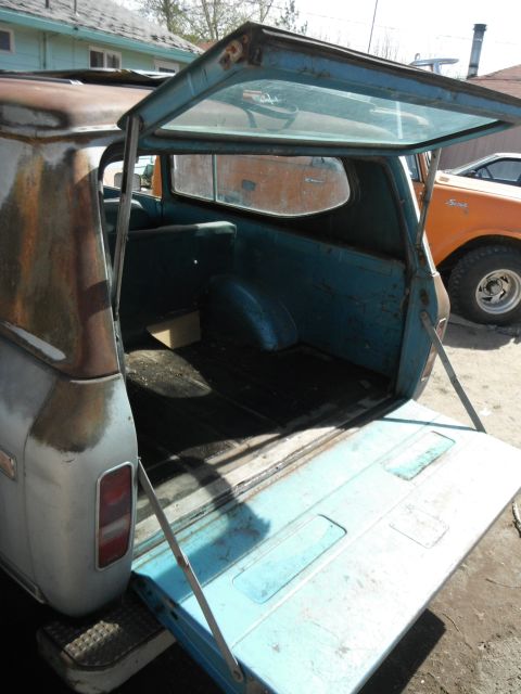 1972 International Scout II - The open tailgate and rear window reveal the interior of a 1972 International Scout II, with another Scout visible in the background.