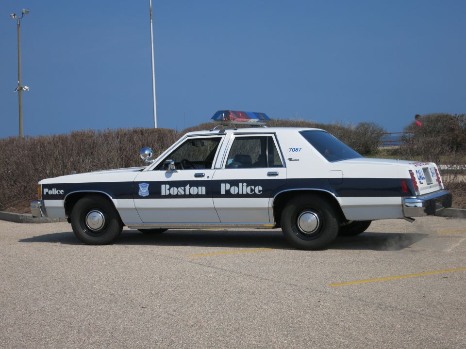 Boston Police Ford LTD Crown Victoria, passenger-side profile near shrubs