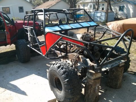 1986 Ford Bronco - This custom-built buggy is undergoing construction, a roll cage and exposed engine components.