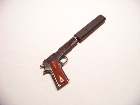 1995 Mercury Grand Marquis - A pistol with a silencer is displayed against a plain background.