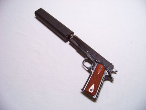 1995 Mercury Grand Marquis - A pistol with a silencer is shown against a white background.
