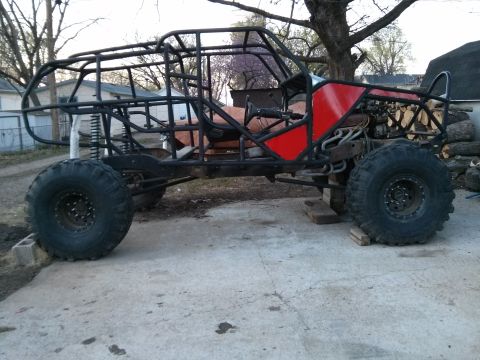 1986 Ford Bronco - This custom-built buggy frame, a roll cage and large off-road tires, is shown from the side.