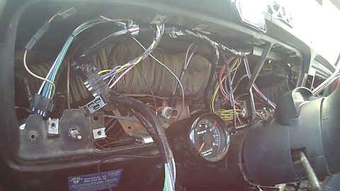 1978 Ford Bronco - Dashboard wiring harness exposed, with a single gauge visible.