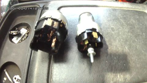 1978 Ford Bronco - Two ignition switch assemblies are shown in a tray with various screws and hardware.