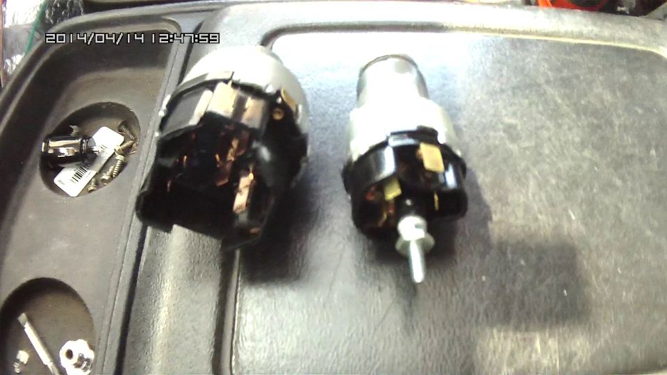 two ignition switch assemblies in a tray with screws