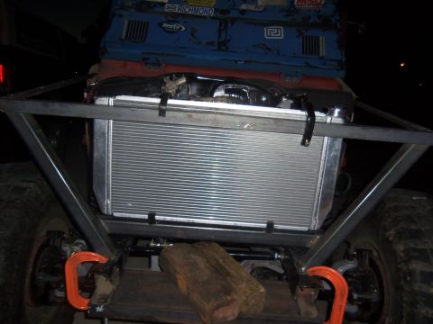 1968 Ford Bronco - Custom front end of an off-road vehicle with a large radiator and metal bracing. The vehicle appears modified.