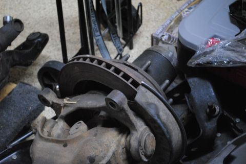 1986 Ford Bronco - Front suspension part with brake rotor and hub assembly, likely for a truck or SUV.