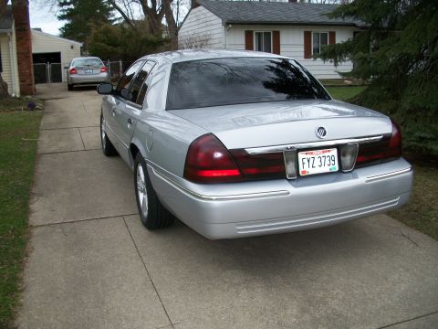 2003 Mercury Grand Marquis - Rear view of a silver 2003 Mercury Grand Marquis sedan with tinted windows.