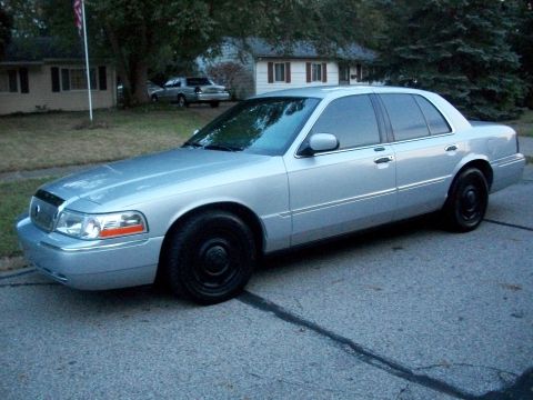 2003 Mercury Grand Marquis - A silver 2003 Mercury Grand Marquis sedan is seen from a three-quarter front angle on a residential street.