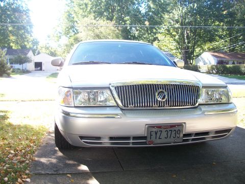 2003 Mercury Grand Marquis - Front view of a silver 2003 Mercury Grand Marquis, its distinctive chrome grille and Ohio license plate.